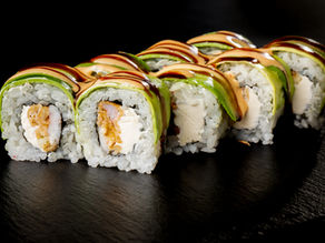 A picture of sushi rolls on a wooden surface