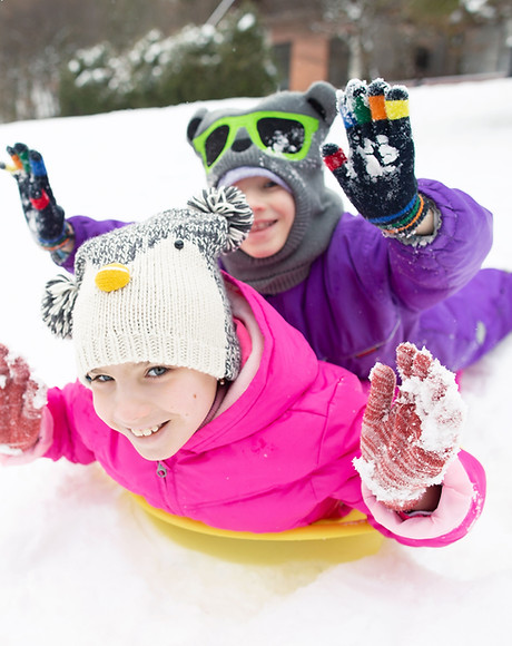Happy Children Sledding in Snow