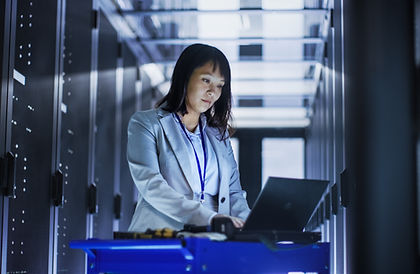 Female employeee working in a server room