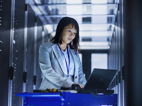 Female employeee working in a server room