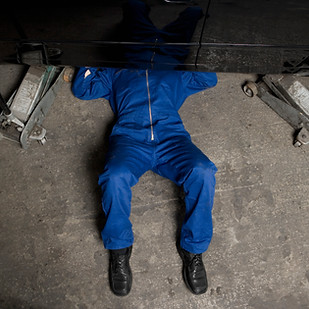 A car mechanic servicing a car