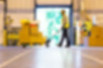 Worker carting boxes in warehouse