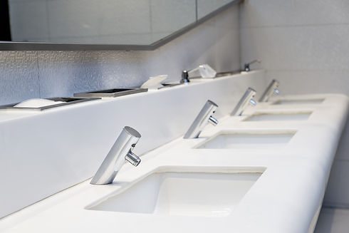 Interior of public toilet. Many faucet and sink in public toilet at hotel