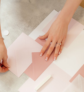 Hands arranging envelopes