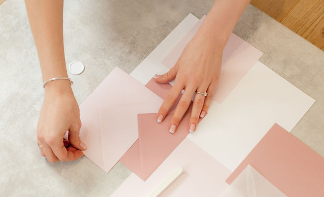 Hands Arranging Envelopes