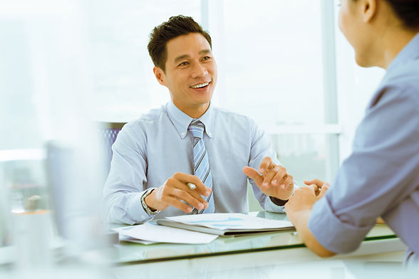 Asian manager giving advice in his office