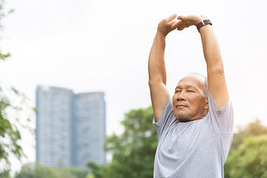Man stretching his shoulders overhead