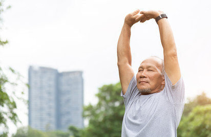 An old man stretching his arms