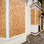 Boarded up windows and debris