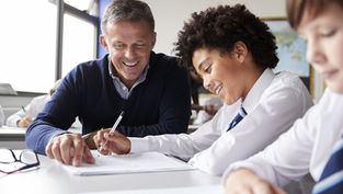Teacher helping an ADHD teenager in school