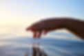 Hand touching calm water