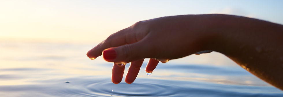 Hand touching calm water