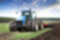 agricultural worker ploughing land on a powerful tractor