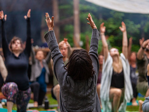 Corporate wellness event with group stretching and support from Nurture Chair Massage