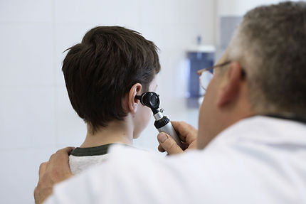 Doctor examining child's ear