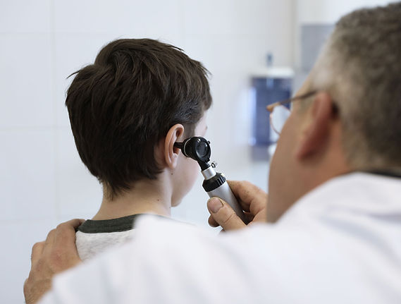 Doctor examining child's ear