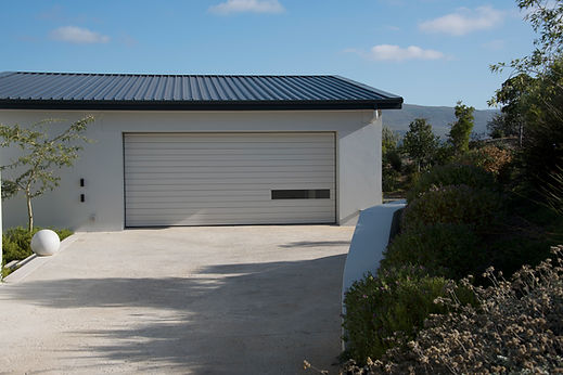 Modern residential garage with smooth resin driveway installation