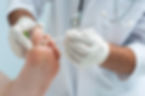 Doctor dermatologist examines a foot