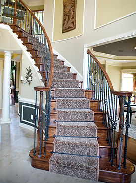 Elegant wooden staircase with carpet