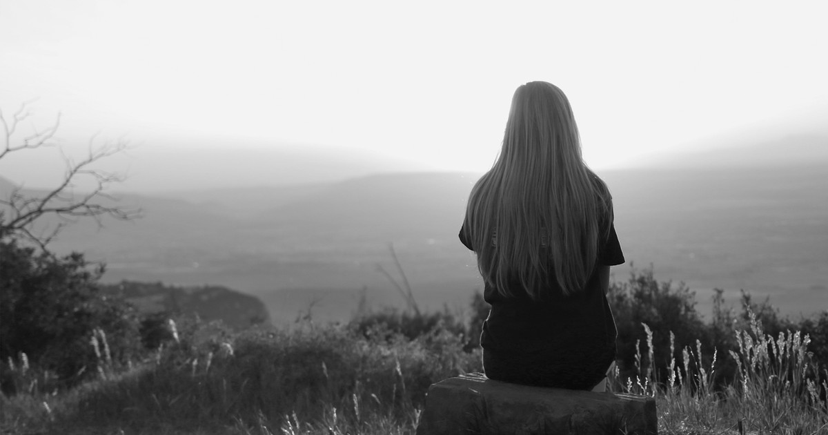 A person reflecting on life changes caused by persistent pain while looking forward with hope and resilience.
