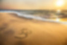 Om Symbol on the Beach