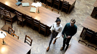 Overhead photo of students standing in a Library