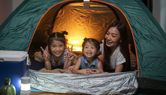 Asian mom camping indoor with her kids