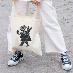 Person holding a tote bag with a simple design