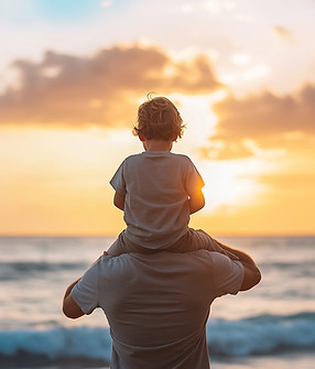 Child on Shoulders at Sunset