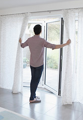 Man opening bi-folding doors