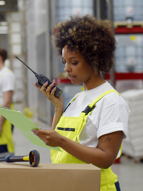 Warehouse worker using radio