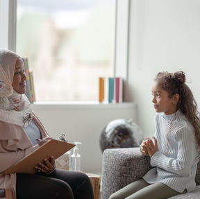 A young female child speaking with a therapist about grief