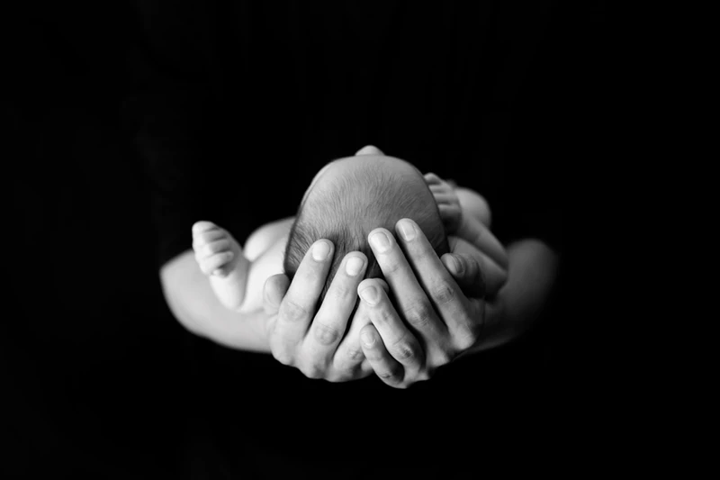 Infant in adult hands