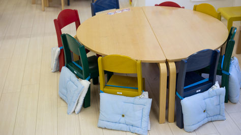 Empty tables and chairs in a licensed child care classroom