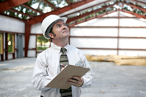 A building inspector examining the the steel girders in a building