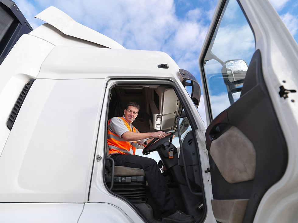 Truck driver looks down from truck