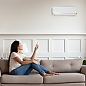 Person Using AC Remote Control