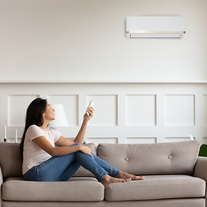 Person Using AC Remote Control