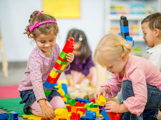 A group of children playing with building blocks.