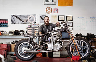 Confident Mechanic with Motorcycle