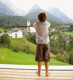 Child on glass balcony