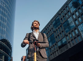 Office worker riding a scooter