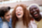 three friends laughing in a group