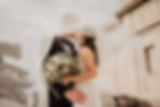 Bride and Groom holding flowers and kissing