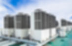 A row of industrial HVAC units on a building rooftop
