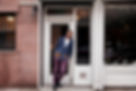 A man standing at a store doorway