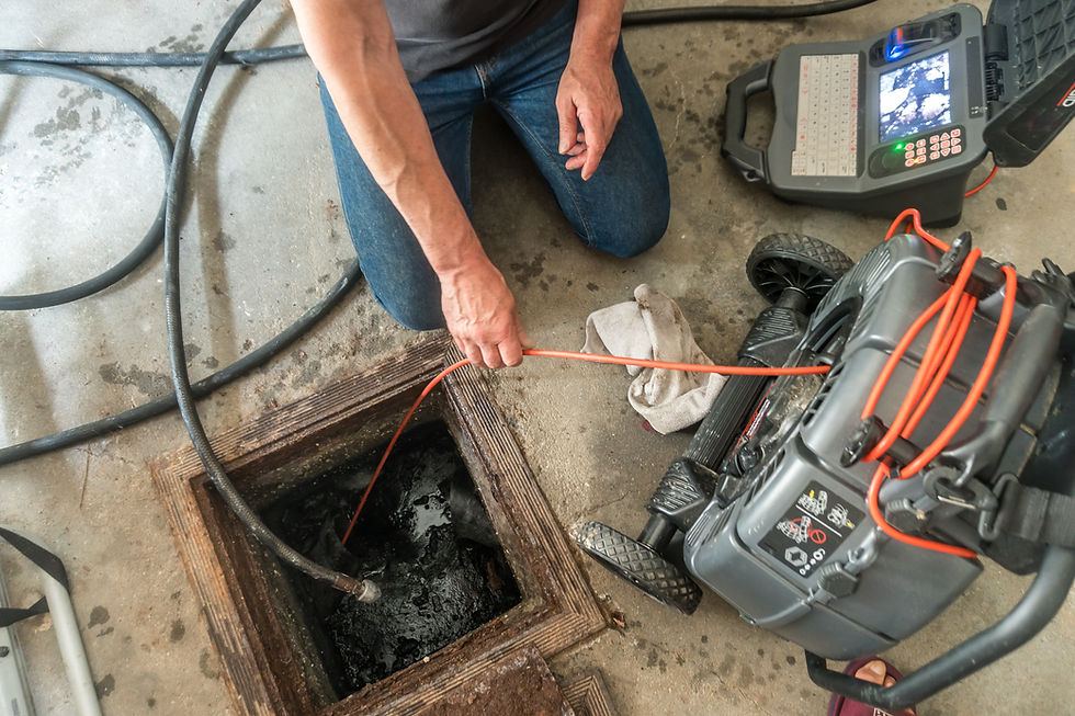 Drain inspection camera display unit showing live video feed of underground pipe blockage