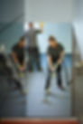 a female cleaning contractor steam cleans an office carpet in a empty office in between te