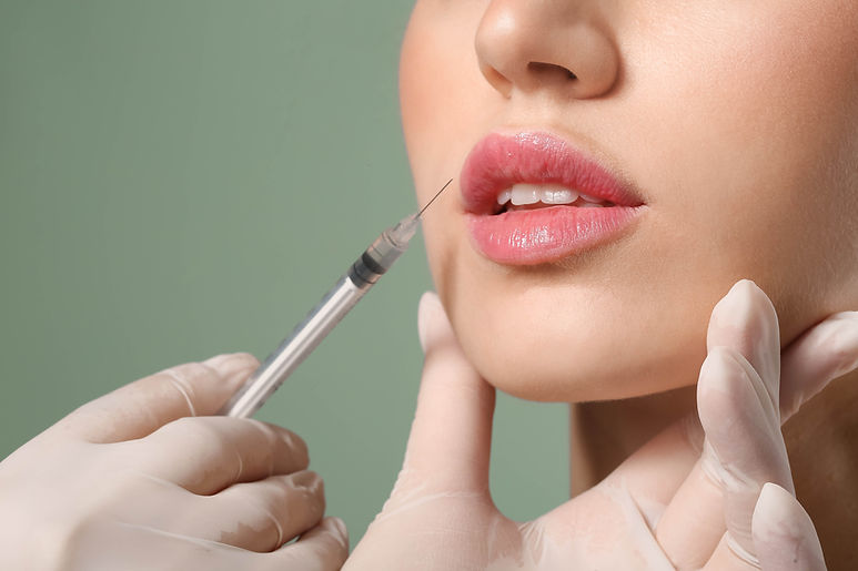 Woman getting lip filler to promote aesthetic services at Elizabeth Grace Aesthetics in York, PA.