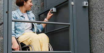 A woman in a wheelchair confidently uses an accessibility elevator